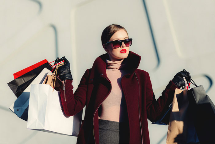 Woman holding shopping bags, representing Amazon's AI revolution in fashion retail. Woman holding shopping bags, representing Amazon's AI revolution in fashion retail.