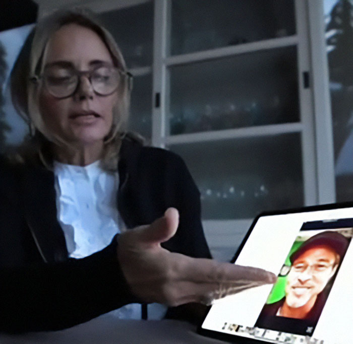 A woman gestures at a tablet displaying an image linked to Brad Pitt's AI scam warning. A woman gestures at a tablet displaying an image linked to Brad Pitt's AI scam warning.