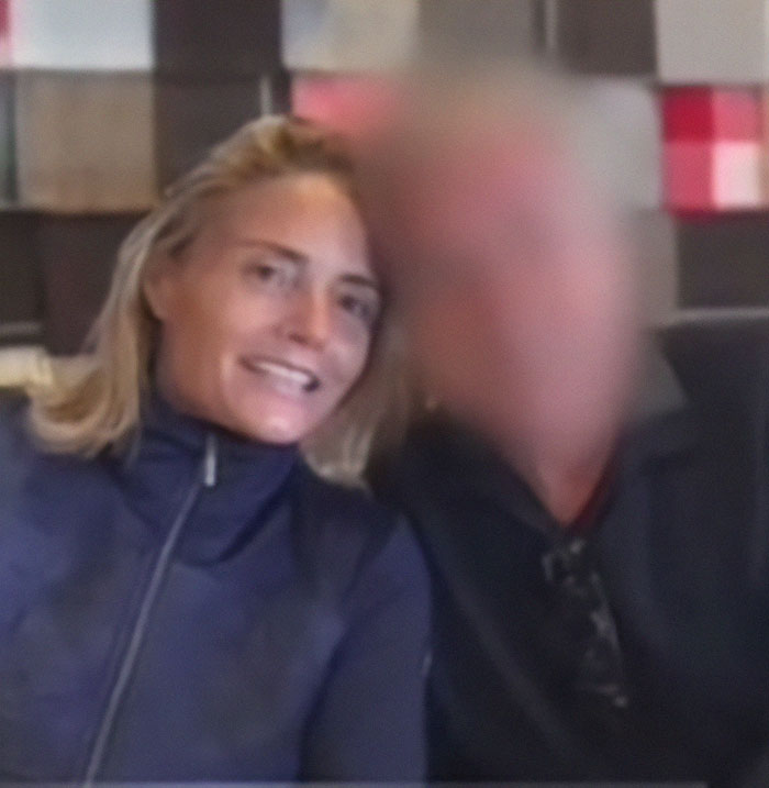 A woman smiles next to a blurred individual related to a fake AI scam involving 800k euros. A woman smiles next to a blurred individual related to a fake AI scam involving 800k euros.