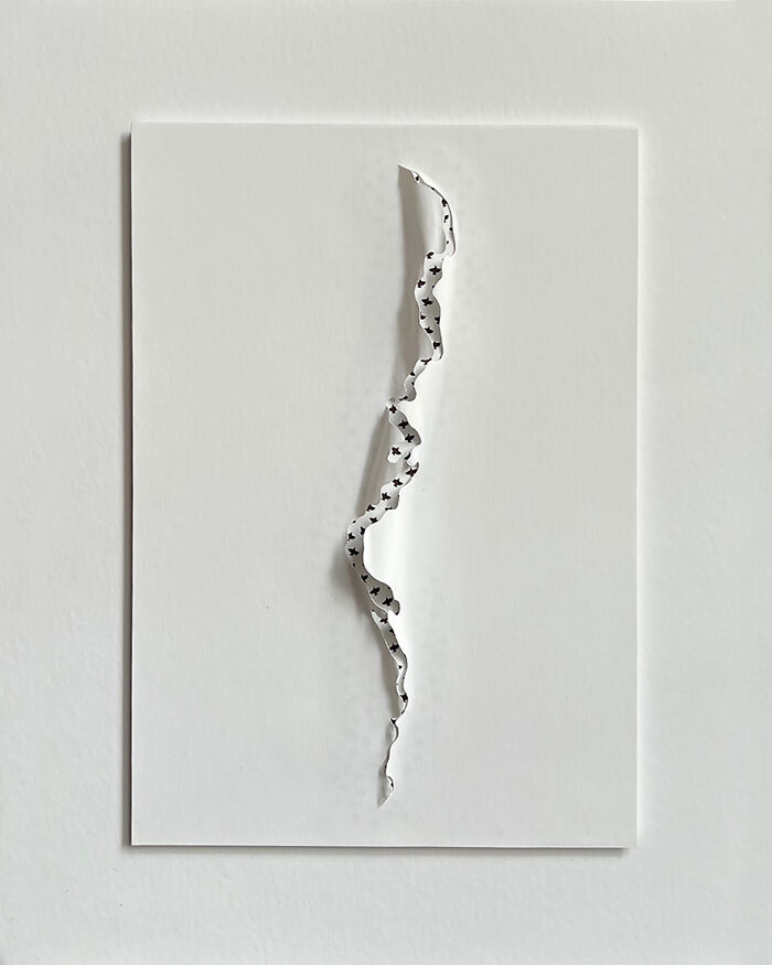 Intricate paper cut design on a white background, showcasing a tree-less existence theme.