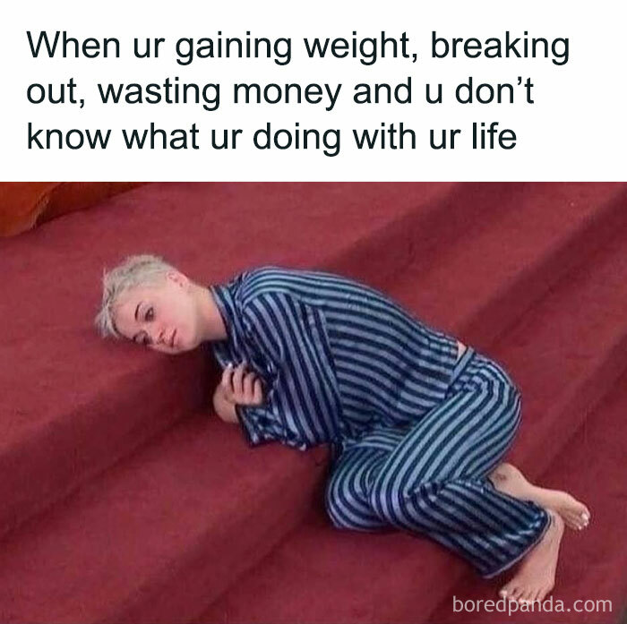 Person in striped pajamas lying on stairs, looking contemplative, capturing an introvert meme vibe.