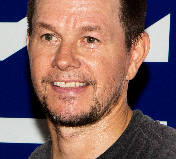 A celebrity smiling in front of a blue and white background, related to secrets and scandals.