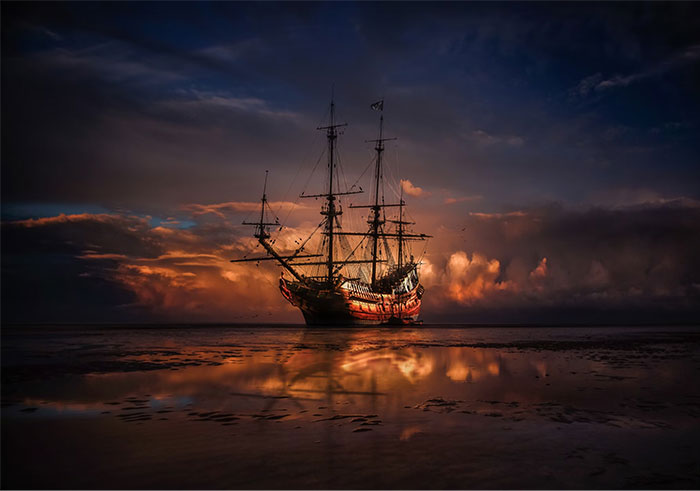 A historic ship on calm water at sunset, symbolizing collective madness and money spent in the past.