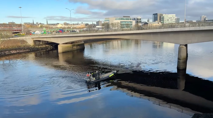 Boat searching river under bridge in hunt for missing sisters who disappeared weeks ago.