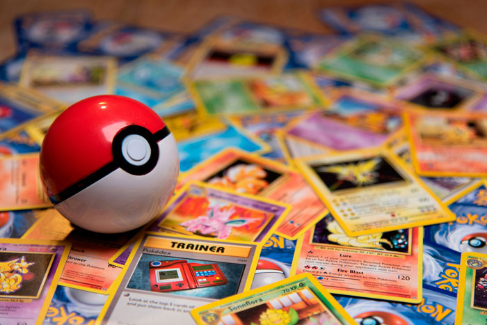 Pokémon cards scattered with a Poké Ball for a boyfriend's Christmas gift.