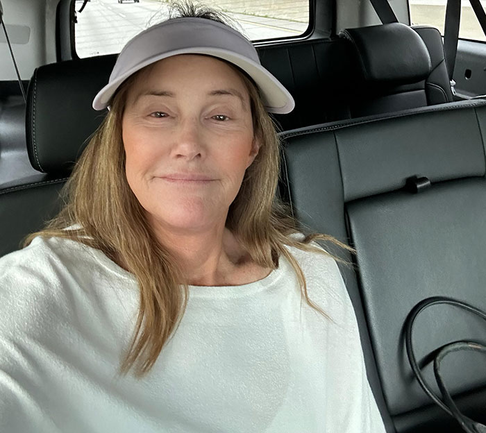 Person in car wearing a white top and cap, related to LA wildfires issue. Person in car wearing a white top and cap, related to LA wildfires issue.