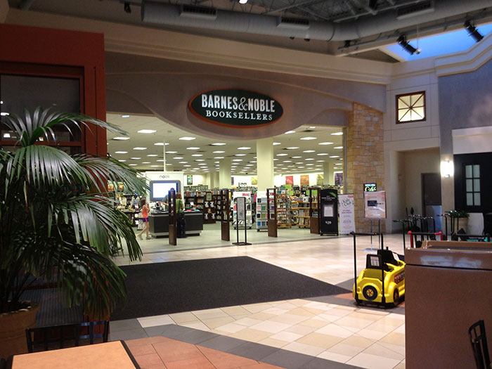 Barnes & Noble bookstore interior, featuring retail displays and a children's toy car.