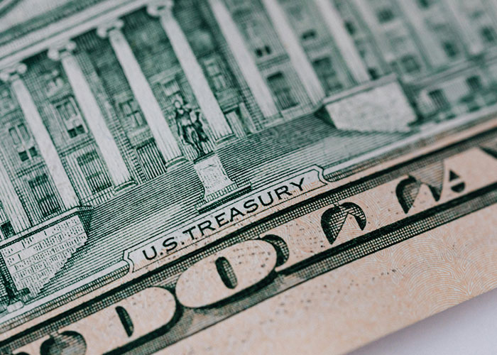Close-up of U.S. Treasury building on a fifty-dollar bill, representing a life cheat code related to finances.
