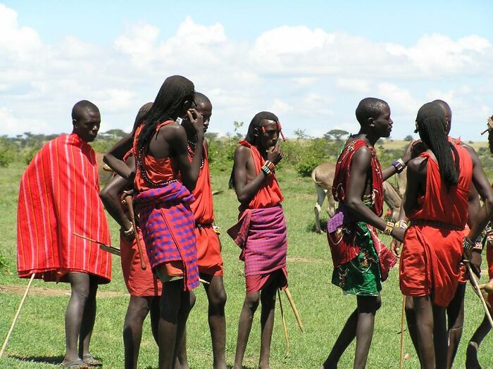 Group of Maasai men in traditional red clothing standing outdoors, illustrating facts you weren’t taught in school history.