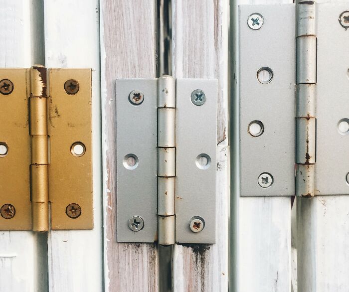 Various metal hinges on doors showing functional yet affordable design.