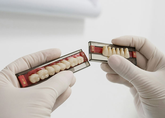 Gloved hands holding dental models, representing unsettling medical facts.
