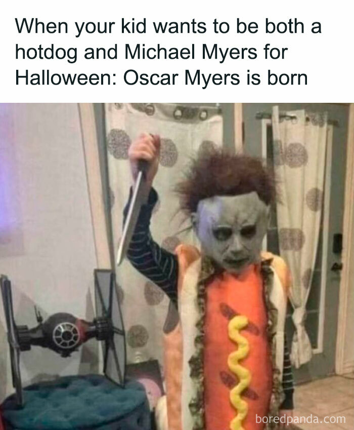 Child in a hotdog and Michael Myers costume holding a knife, humorously capturing the joys and struggles of a dad.
