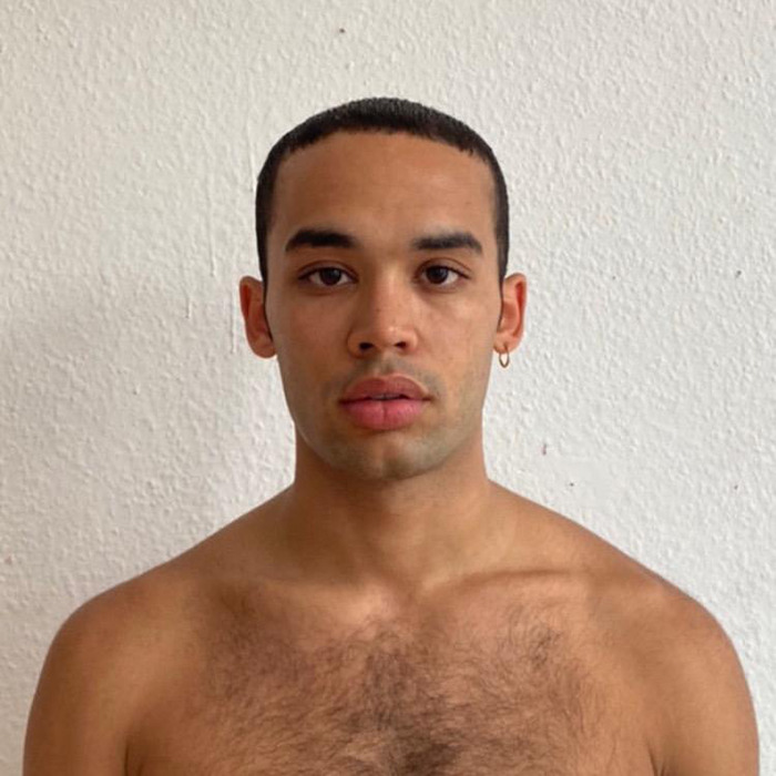 Kanah Flex with neutral expression against a plain background. Kanah Flex with neutral expression against a plain background.