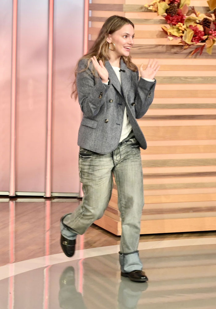 Dafne Keen in a grey blazer and jeans on a set with autumn decor, representing a Deadpool cast cameo surprise.