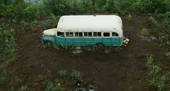 Abandoned bus in a remote forest setting, symbolizing sad and depressing movie endings.