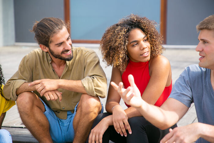 Group of young people chatting, displaying signs of intelligence through engaged conversation.