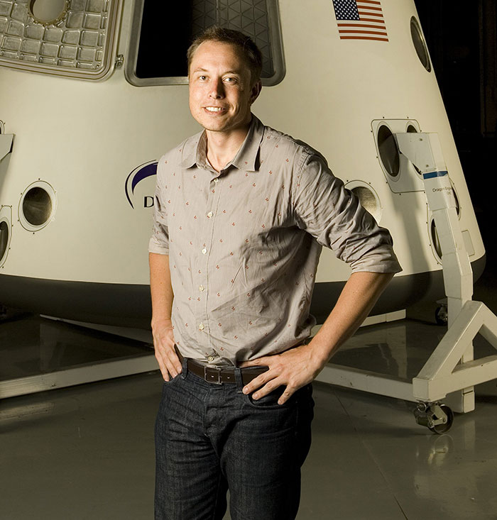 Man in casual attire standing in front of a spacecraft, representing a wealthy entrepreneur. Man in casual attire standing in front of a spacecraft, representing a wealthy entrepreneur.
