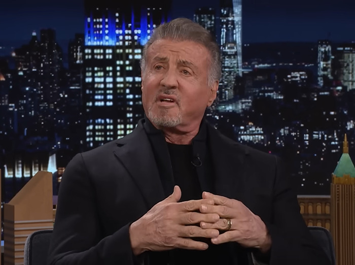 Sylvester Stallone talking on a show, background shows a city skyline. Sylvester Stallone talking on a show, background shows a city skyline.