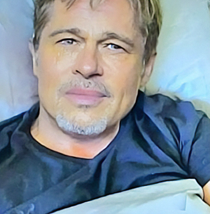 Man resembling Brad Pitt in a casual setting, wearing a black t-shirt, connected to fake AI scam news. Man resembling Brad Pitt in a casual setting, wearing a black t-shirt, connected to fake AI scam news.