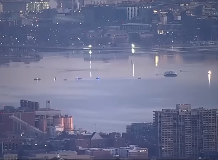 Aerial view of a cityscape near water, related to concerning practice at civilian airports. Aerial view of a cityscape near water, related to concerning practice at civilian airports.