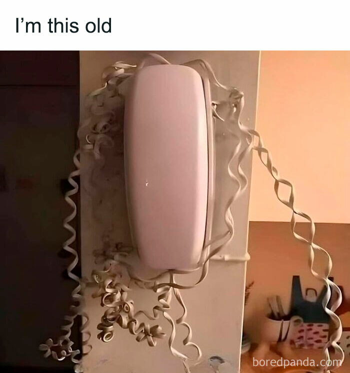 Old rotary phone with tangled cord evokes Gen X nostalgia.
