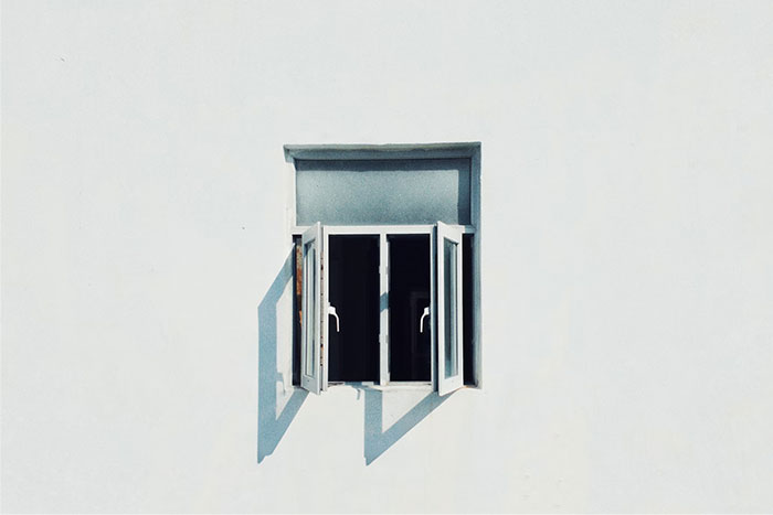 Open window on a minimalist white wall, symbolizing surprising cultural insights.