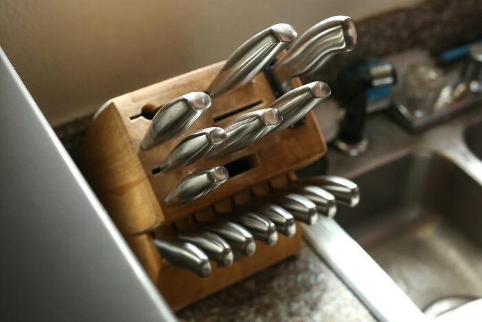 Knife set in a wooden block on a kitchen counter, enhancing organization and convenience.