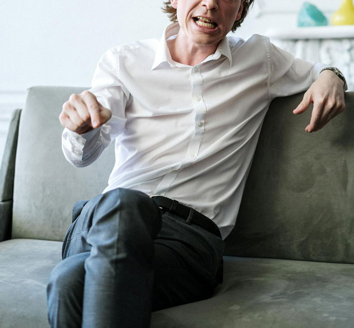 Man in a white shirt sitting on a couch, discussing research to invent a new color. Man in a white shirt sitting on a couch, discussing research to invent a new color.