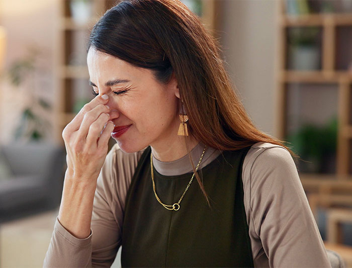 Woman appearing stressed at home, related to concerns about a social security number and background check. Woman appearing stressed at home, related to concerns about a social security number and background check.