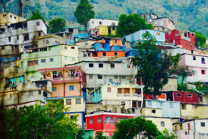 Colorful hillside houses in a densely packed neighborhood, representing a country mentioned negatively by travelers.