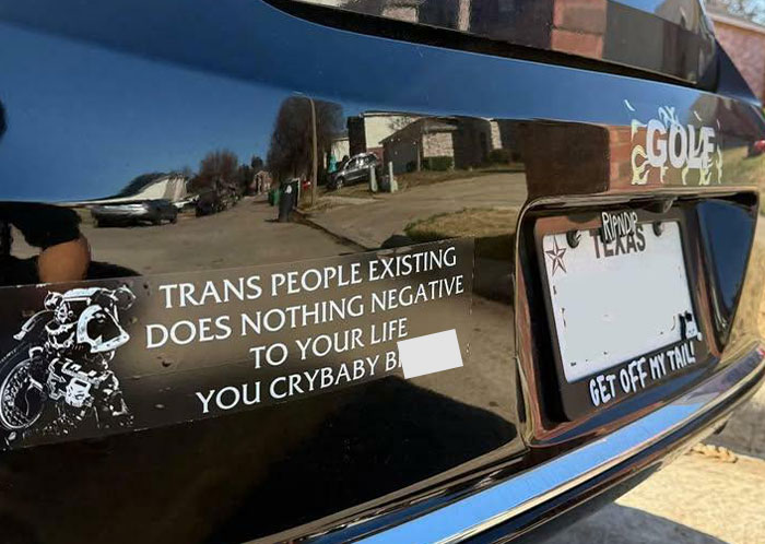 Bumper sticker with a humorous message about coexistence on a car.