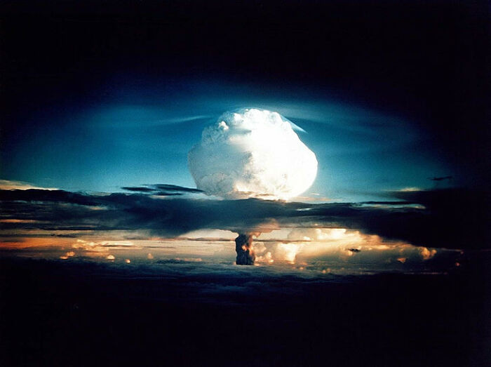 Mushroom cloud of a nuclear explosion at dusk illustrating impactful facts about history not taught in school.