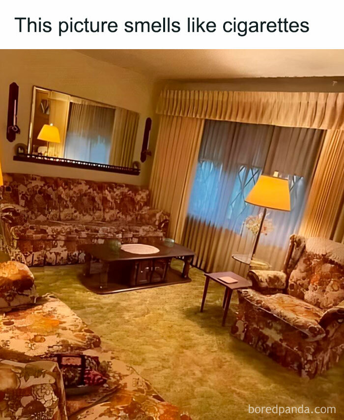 Nostalgic living room with vintage floral furniture, s**g carpet, and warm lighting.