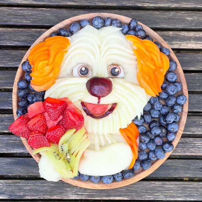 Fruit arranged artistically into a dog shape, using healthy ingredients, showcasing creative food art.