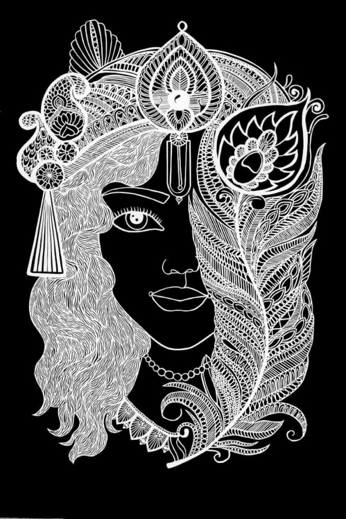 Intricate paper-cutting art of a woman's face, featuring detailed patterns and a peacock feather on a black background.