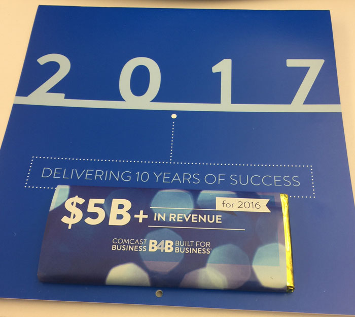 Chocolate bar with 2017 card highlighting company gifts and bonuses, featuring $5B revenue message.