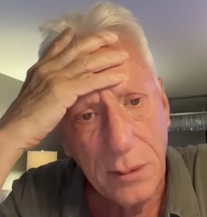 A concerned person holds their head, related to celebrities and LA wildfires. A concerned person holds their head, related to celebrities and LA wildfires.