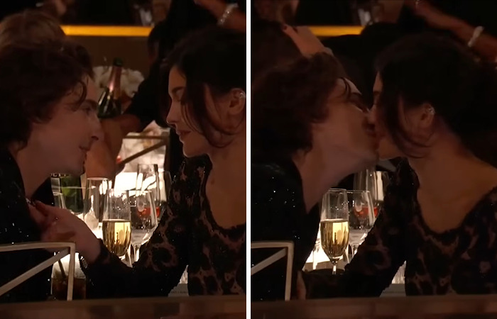 Kylie Jenner and Timothee Chalamet in an awkward moment at an awards show, leaning in for a kiss over a table with wine glasses.