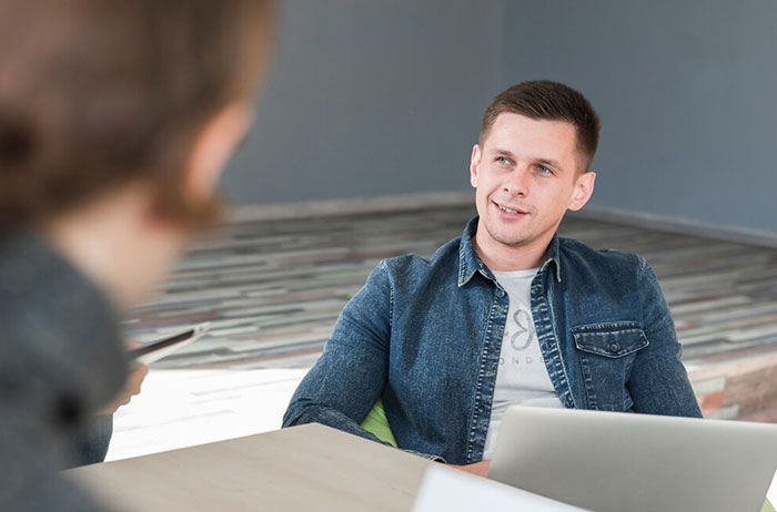 Man in denim jacket during a recruitment interview, highlighting potential employee red flags.