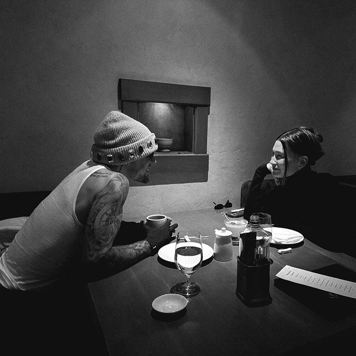 Hailey Bieber shares a candid dining moment with Justin, engaging in conversation. Hailey Bieber shares a candid dining moment with Justin, engaging in conversation.