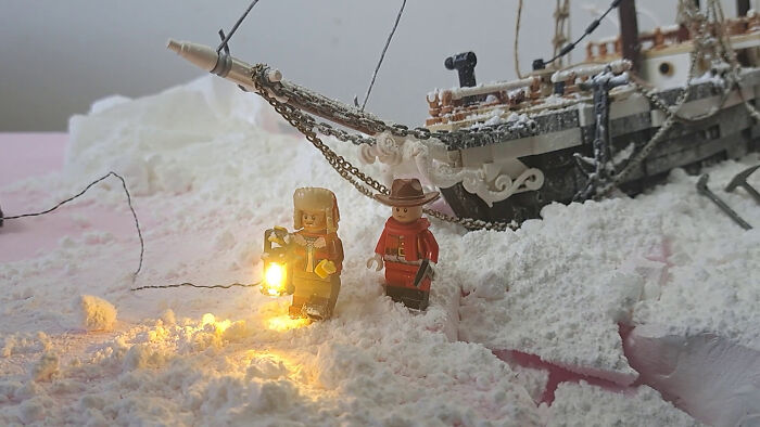 LEGO figures reimagining the Imperial Trans-Antarctic Expedition in snowy setting with ship in background.