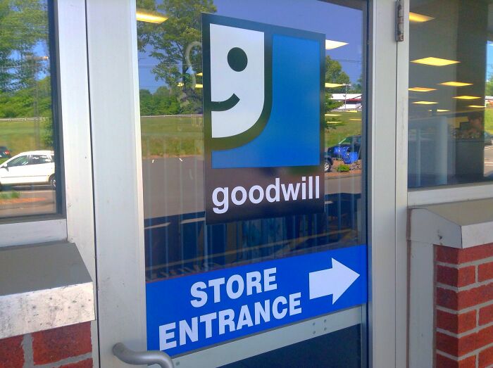 Goodwill store entrance with logo on glass door, illustrating false advertisements concept.