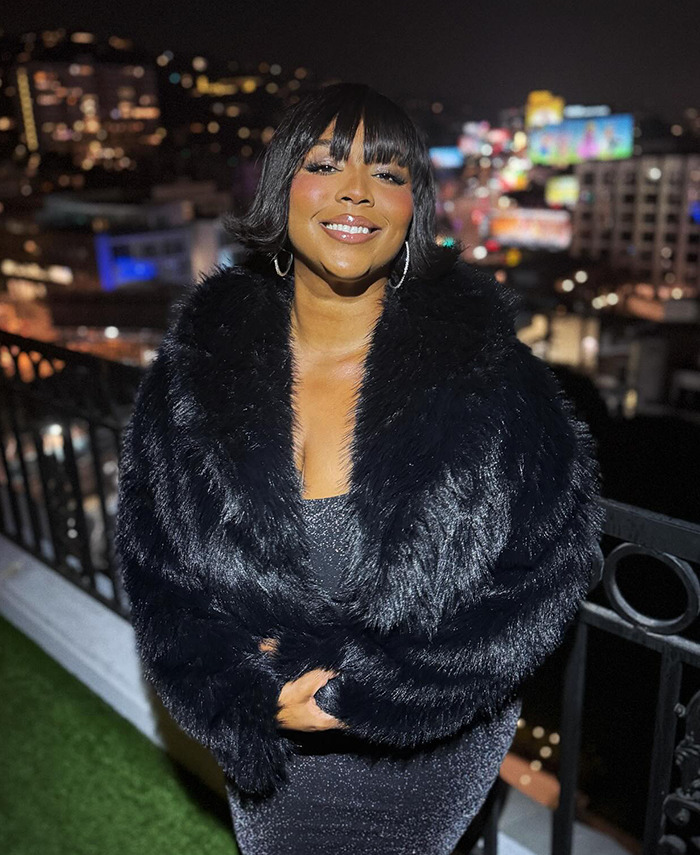 Lizzo in a black fur coat smiles confidently at night, embracing her weight loss journey. Lizzo in a black fur coat smiles confidently at night, embracing her weight loss journey.