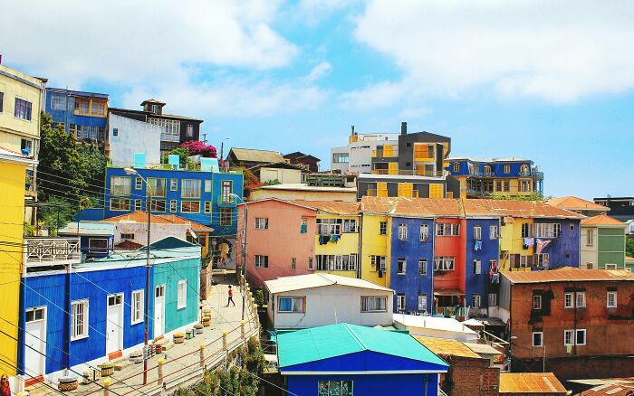 Colorful hillside buildings beneath a blue sky in the worst country ever visited.