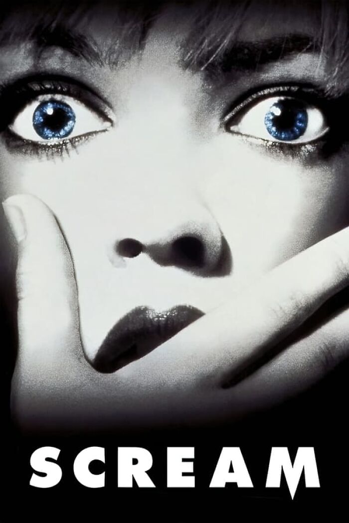 Close-up of a woman's face with scared eyes, representing nostalgia movies.