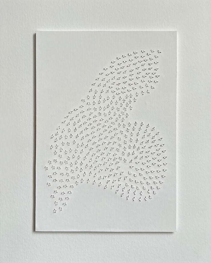 Intricate paper cut design showcasing tree-less existence, with delicate patterns on a white background.