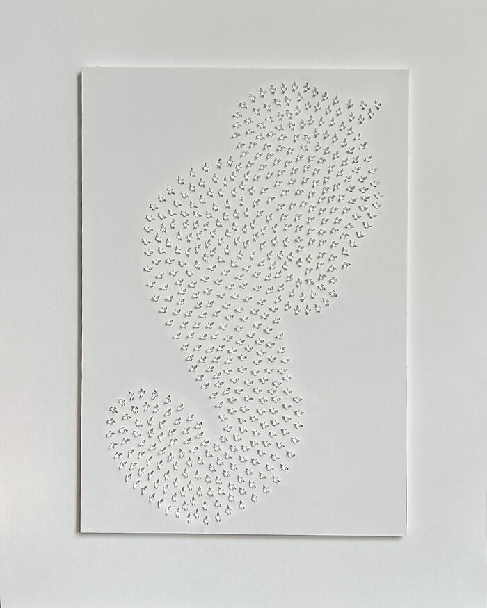 Intricate paper cut design showcasing a swirling pattern on a white background, symbolizing tree-less existence.