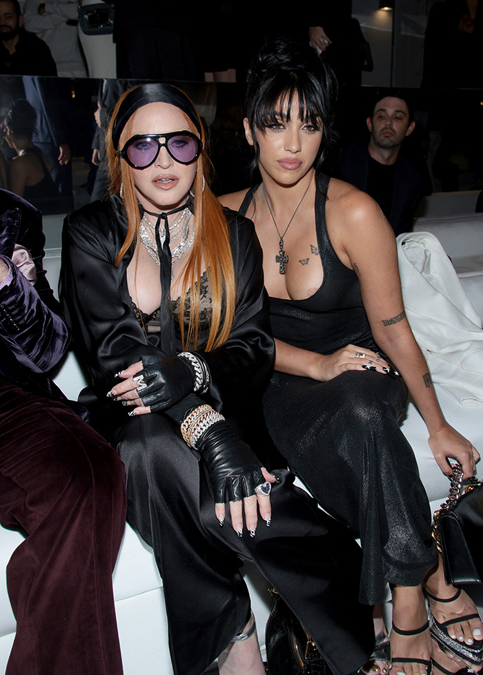 Madonna and Lourdes Leon seated at a fashion event.