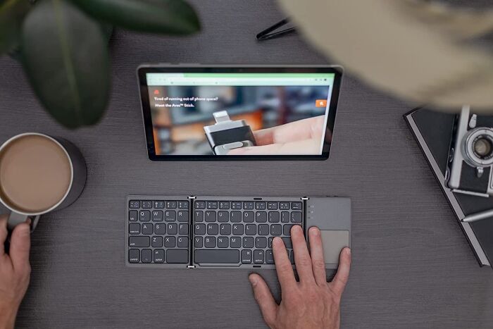 Tablet setup with foldable keyboard, enhancing productivity on a budget.