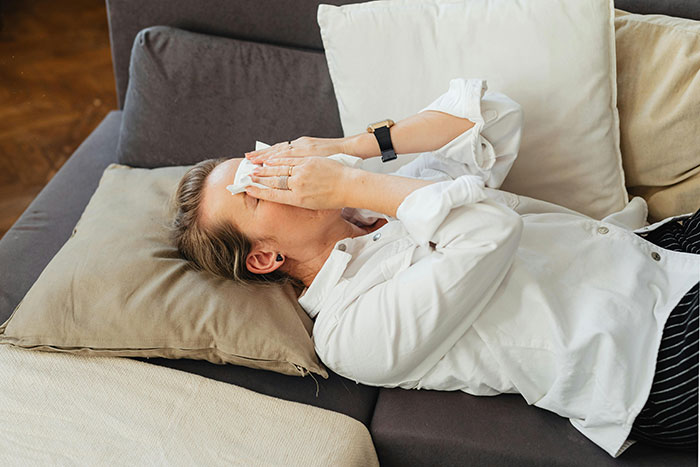Woman lying on a sofa looking distressed, representing infidelity accusations and emotional hardship. Woman lying on a sofa looking distressed, representing infidelity accusations and emotional hardship.